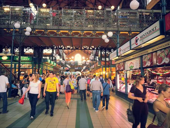 Budapest indoor market with shoppers and food stalls