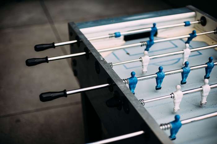Foosball table with blue and white players