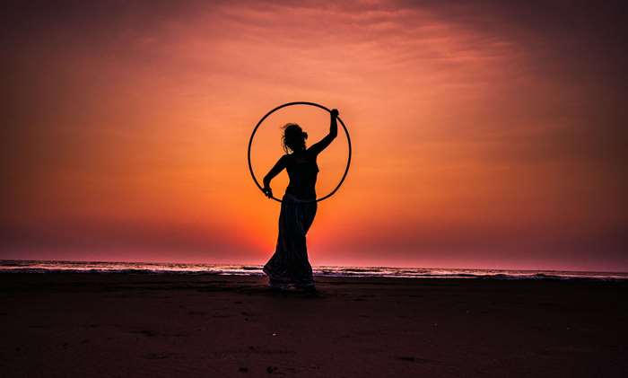 Silhouette of Woman with Hula Hoop at Sunset 4K