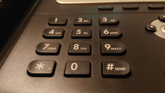 Close-up of a telephone keypad with numbers and symbols