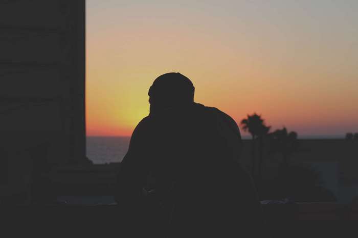 Man on balcony watching sunset in Tel Aviv 4K