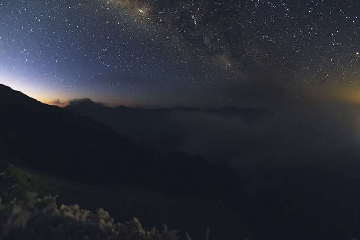 Milky Way over Foggy Mountains at Dawn