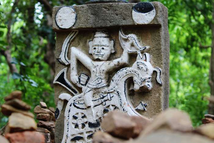 Stone carving of a deity riding a mythical creature