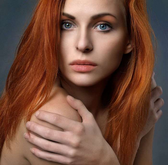 Portrait of a young woman with long red hair