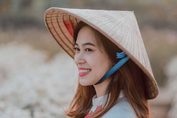 Young Vietnamese woman wearing a conical hat