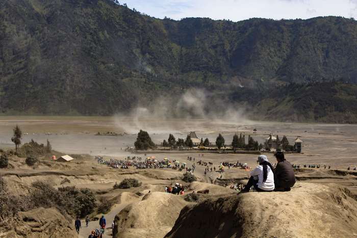 Volcanic landscape with people and smoke at Mount Bromo, Indonesia