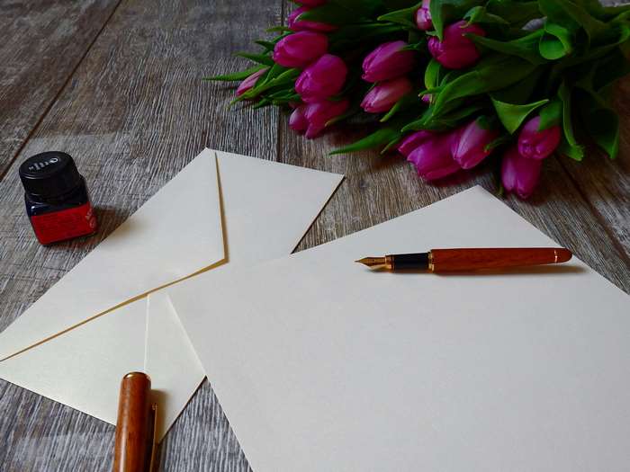 Tulips, Fountain Pen, Ink, and Envelopes on a Wooden Table 4K