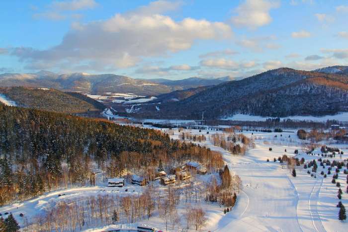 Winter landscape with snow-covered mountains and trees in Hokkaido, Japan