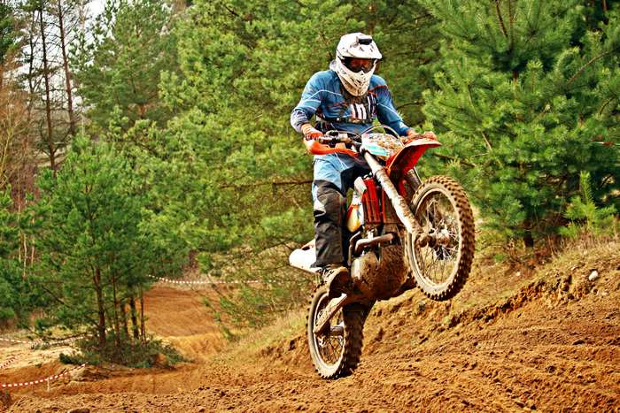 Motocross rider on a dirt bike on a sandy track
