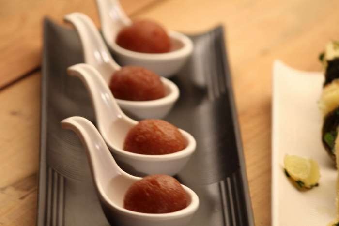 Gulab Jamun dessert served in white spoons