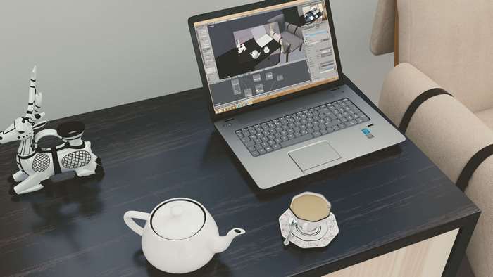 Laptop, tea, and decorative deer on a desk