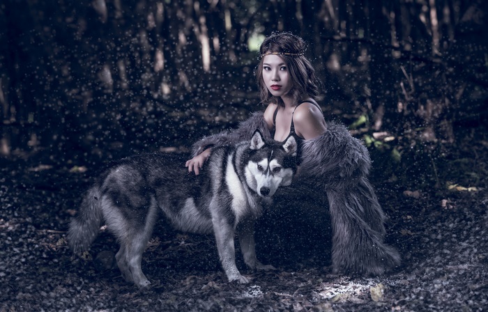 Brunette Asian Woman with Husky in Snowy Forest