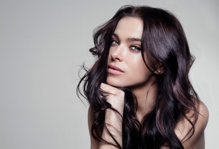 Woman with long dark hair and blue eyes