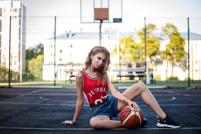 Woman in Detroit basketball jersey with basketball
