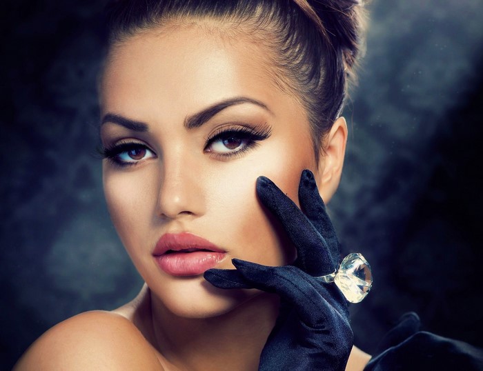 Woman with diamond ring and black glove