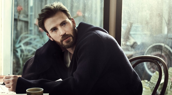 Chris Evans wearing a dark sweater indoors
