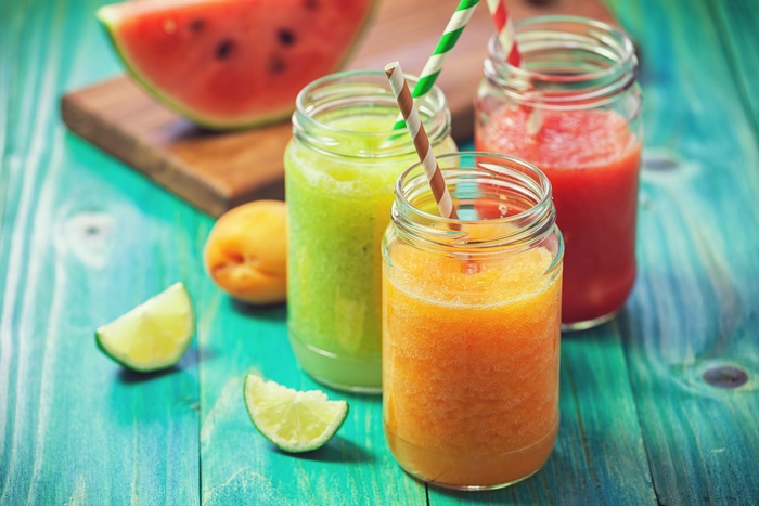 Three colorful fruit smoothies with watermelon and lime