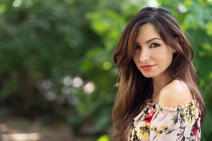 Woman with long brown hair and floral top