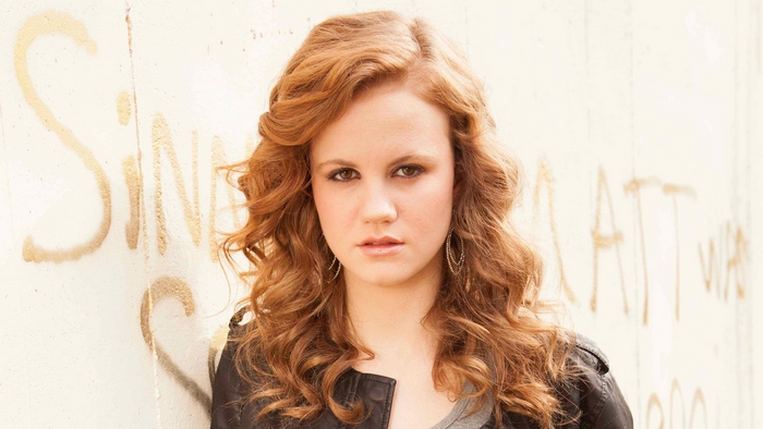 Mackenzie Lintz posing against a graffiti wall