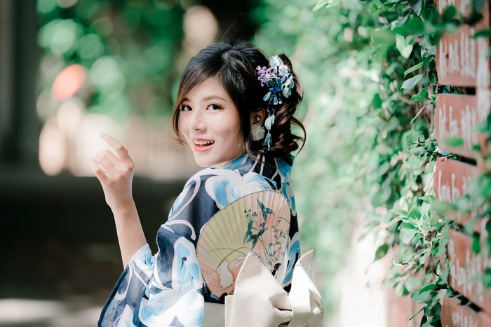 Woman in Kimono Holding a Fan