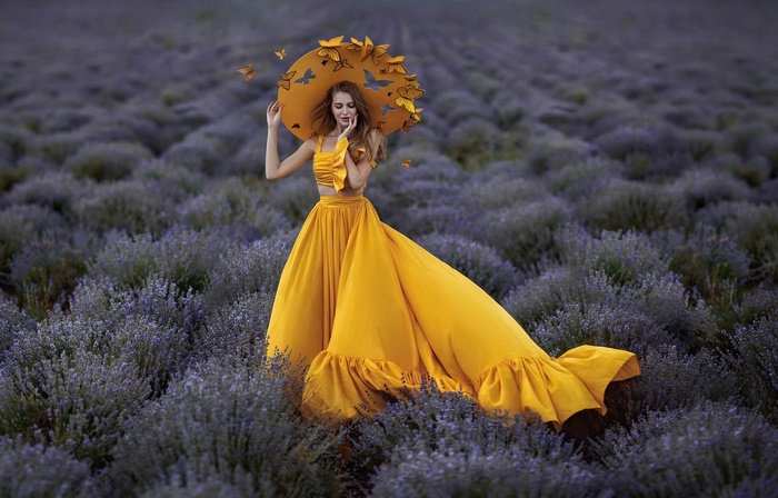 Woman in yellow dress with butterflies in lavender field
