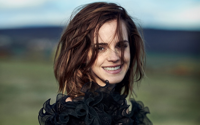 Smiling Emma Watson with Tousled Hair Outdoors