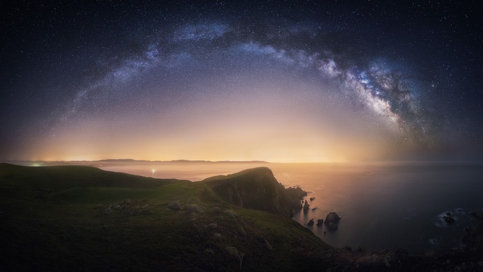 Milky Way Arching Over Coastal Landscape at Night
