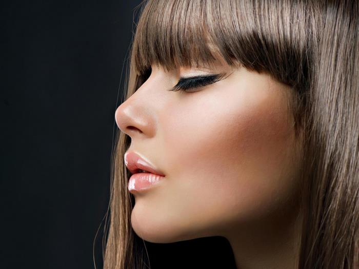 Woman with bangs and winged eyeliner