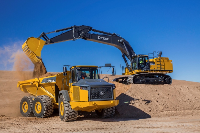 John Deere 670G Excavator dumping dirt into John Deere 370E Dump Truck