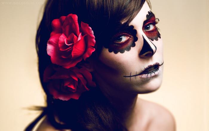 Woman with Sugar Skull makeup and red roses