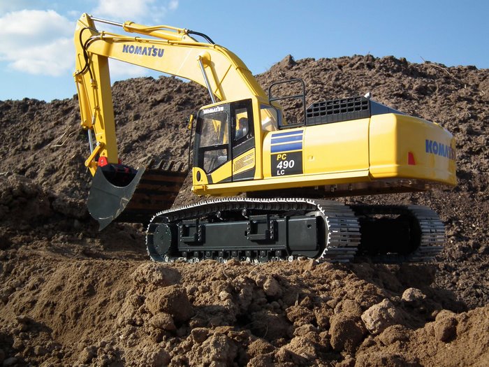 Yellow Komatsu PC490LC Excavator on dirt pile