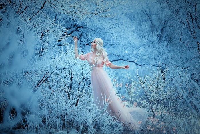 Woman with White Hair in Pink Dress in Snowy Forest