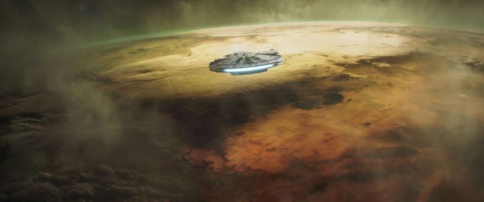 Millennium Falcon over a planet in Solo: A Star Wars Story