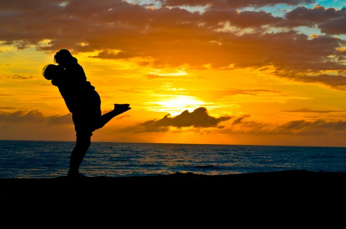Couple kissing at sunset on beach