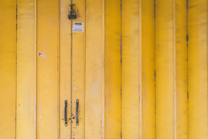 Yellow rolling shutter door with lock and handles