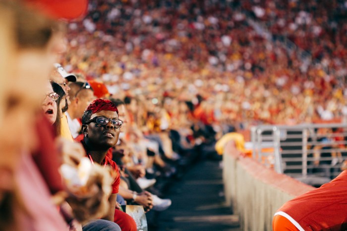 Spectators in stadium watching a football event