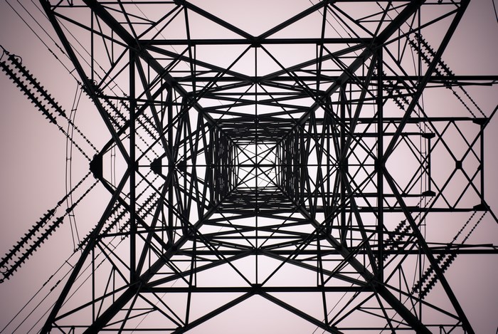 Looking up at a steel electricity pylon structure