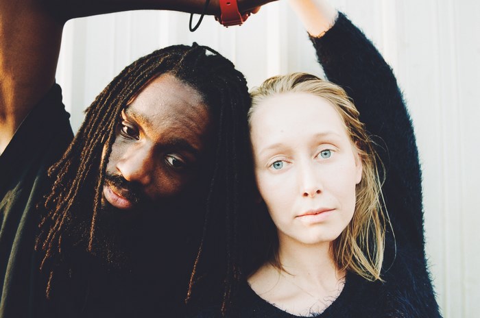 Man with dreadlocks and woman with blue eyes