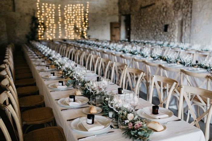 Wedding reception with long tables and string lights