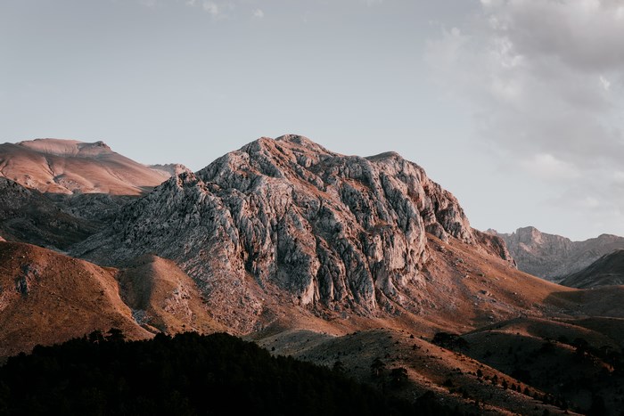 Mountain range at sunset with clouds