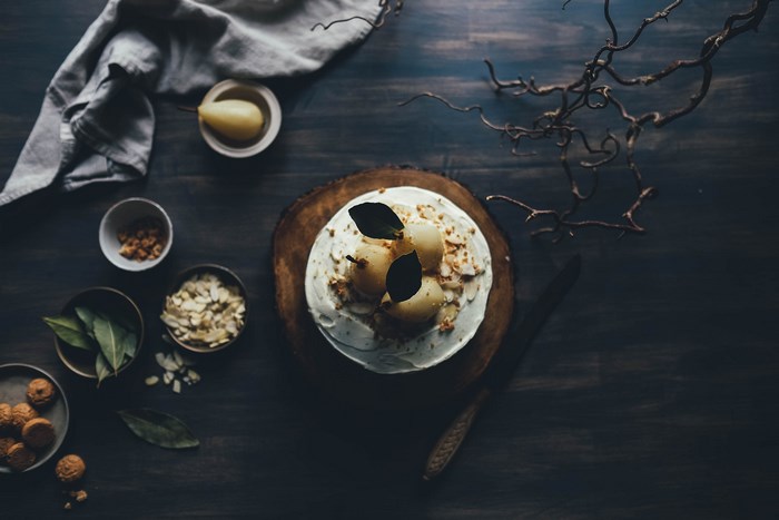 Dessert with pears and nuts on a wooden table