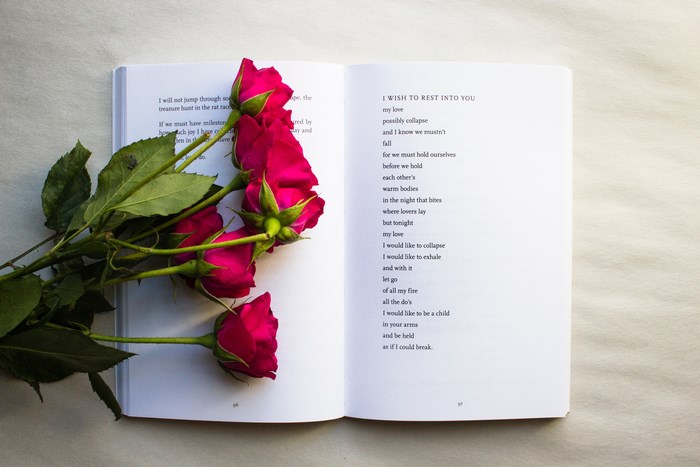 Open book with pink roses and poetry