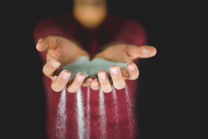 Person pouring sand from hands