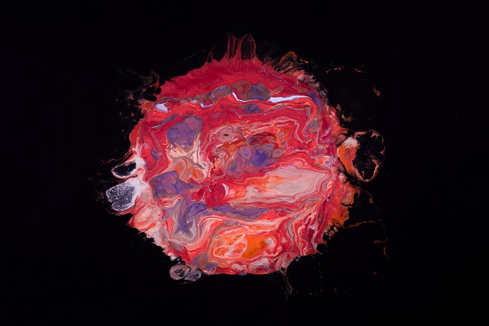 Abstract colorful paint splatter on black background