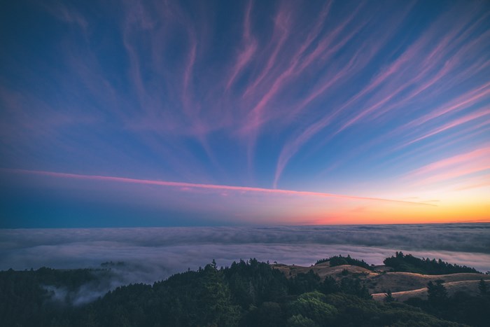 Sunset over Forested Mountains with Colorful Sky