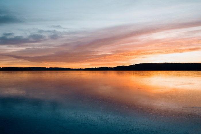 Calm lake reflection at sunset in Sweden