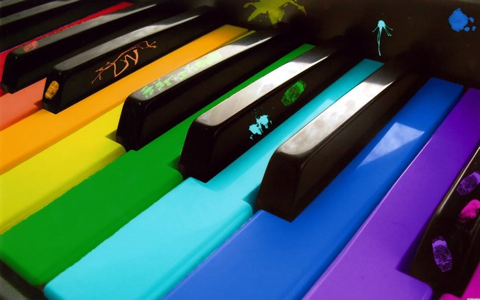 Rainbow piano keys with paint splatters