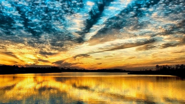 Sunset over a lake with colorful clouds