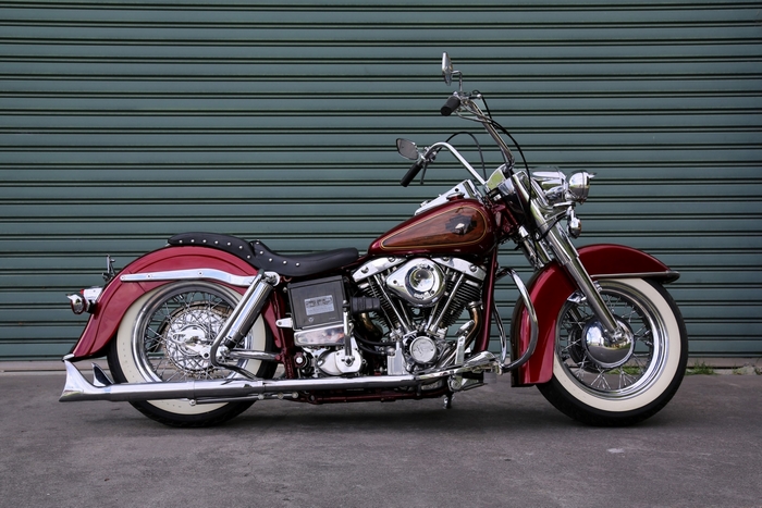 Red Harley Davidson Motorcycle parked in front of a garage door