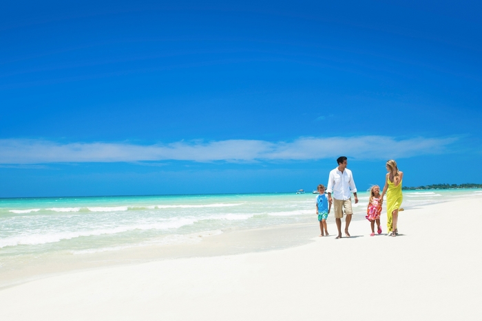 Family walking on a tropical beach